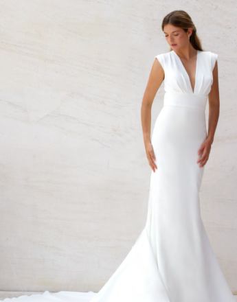 A woman in a white dress with a plunging neckline