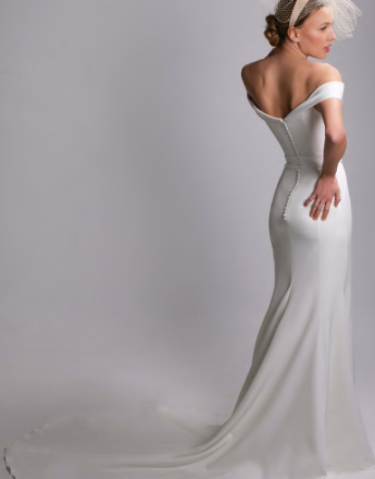 A woman in a white dress with a veil on her head