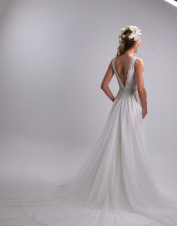 A woman in a white wedding dress with flowers in her hair