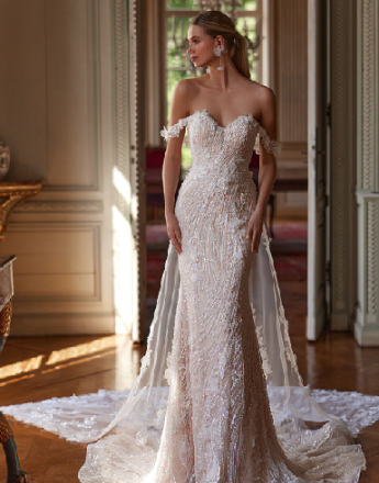 A woman in a wedding dress is standing in a room.
