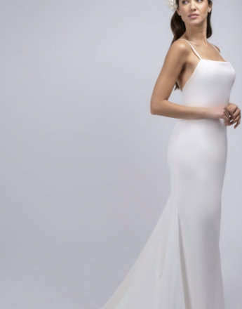 A woman in a white dress with a flower in her hair