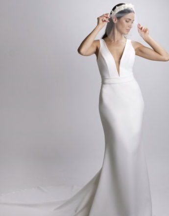 A woman in a white dress with a veil on her head