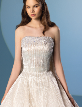 A woman is wearing a white strapless dress