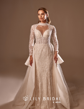 A woman is wearing a white wedding dress with long sleeves.