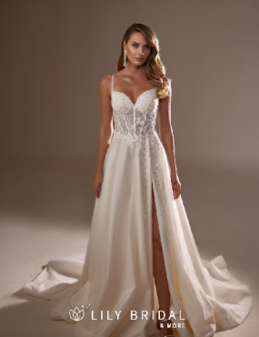 A woman is wearing a white wedding dress with a high slit.