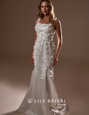A woman is wearing a white wedding dress from lily bridal
