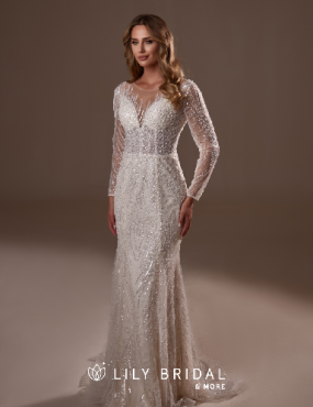 A woman is wearing a white wedding dress with long sleeves.