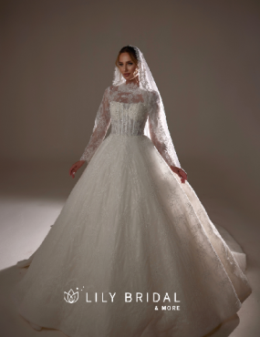 A woman is wearing a wedding dress from lily bridal