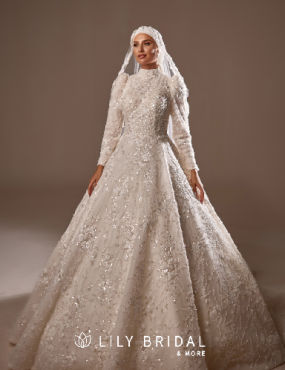 A woman is wearing a white wedding dress and a hijab.