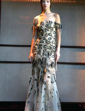 A woman in a long dress with a leopard print on it