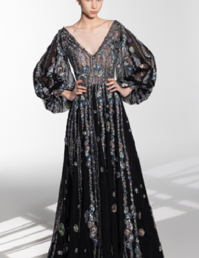 A woman in a long black dress with sequins on it