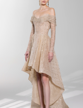 A woman is wearing a high low dress with long sleeves