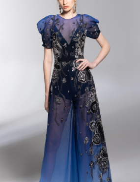 A woman is wearing a long blue dress with puffed sleeves