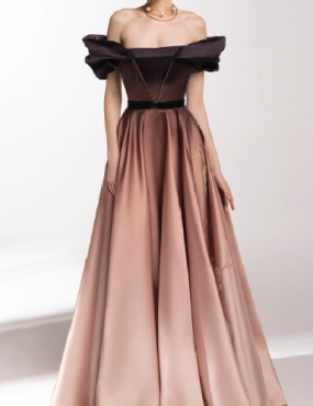 A woman is wearing a long dress with off the shoulder sleeves.