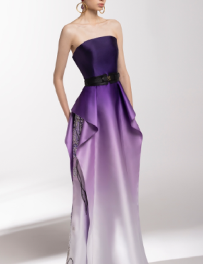 A woman is wearing a purple strapless dress with a black belt.