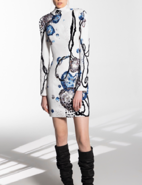 A woman wearing a white dress and black boots