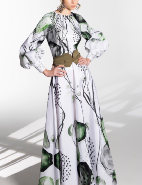 A woman is wearing a long white dress with green flowers on it