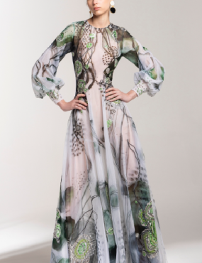 A woman is wearing a long dress with a floral print