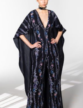 A woman is wearing a black jumpsuit with a choker around her neck