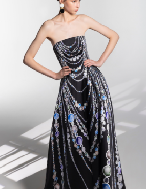 A woman in a black strapless dress with chains on it