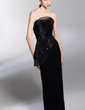 A woman is wearing a black strapless dress