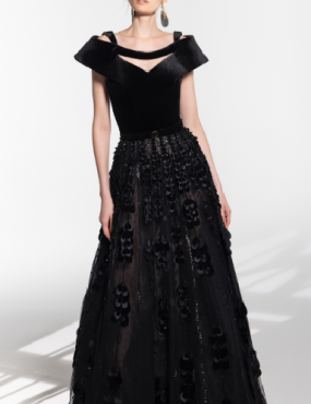 A woman is wearing a black dress and earrings