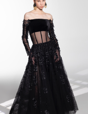 A woman is wearing a black dress with long sleeves