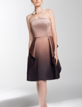 A woman is wearing a strapless dress and a pearl necklace