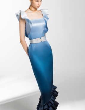 A woman in a long blue dress with ruffles on the skirt