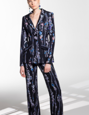 A woman is wearing a suit with chains on it