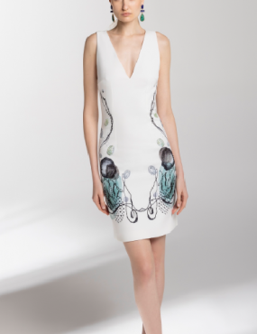 A woman is wearing a white dress with flowers on it