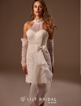 A woman is wearing a white dress and gloves.