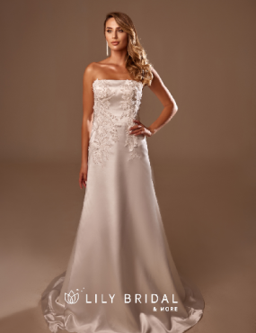 A woman is wearing a white wedding dress from lily bridal