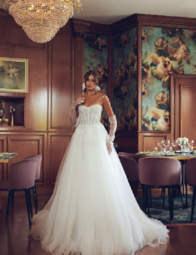 A woman in a wedding dress is standing in a room