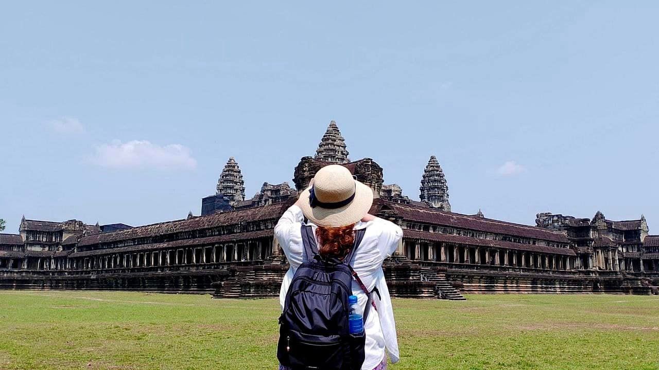 Tourists exploring the ancient Angkor Wat temple in Siem Reap, Cambodia during a 15-day itinerary.