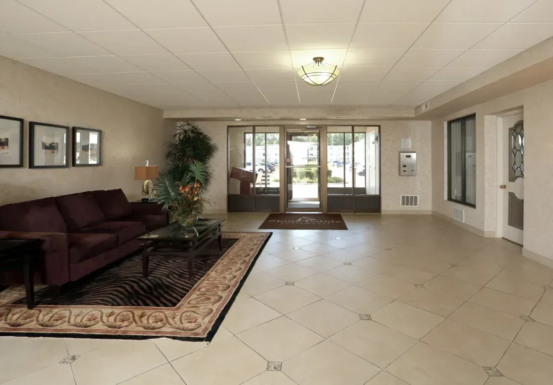 A living room with a couch a coffee table and a rug