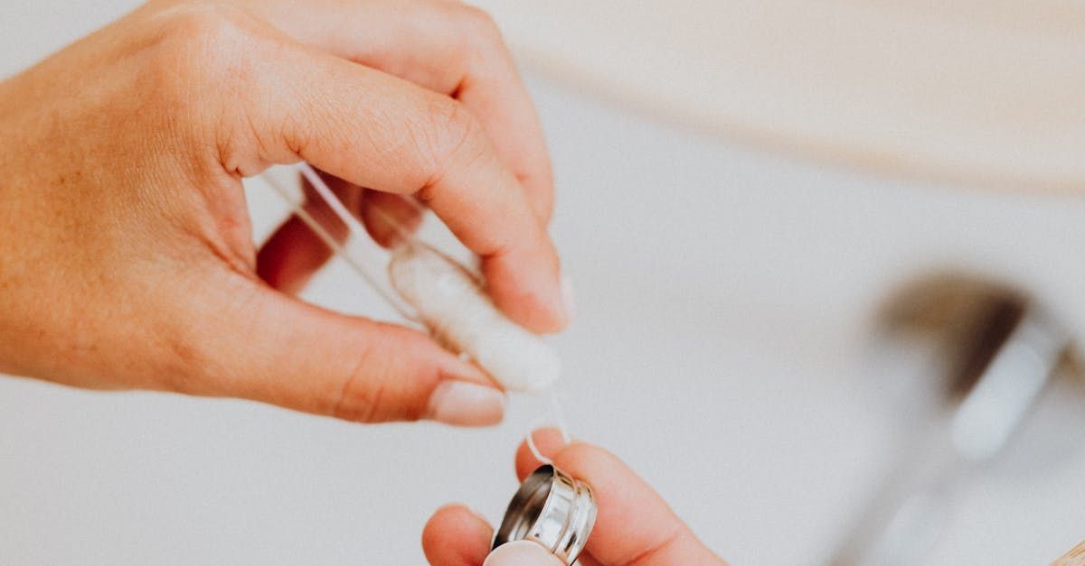 A close up of a hand holding floss.