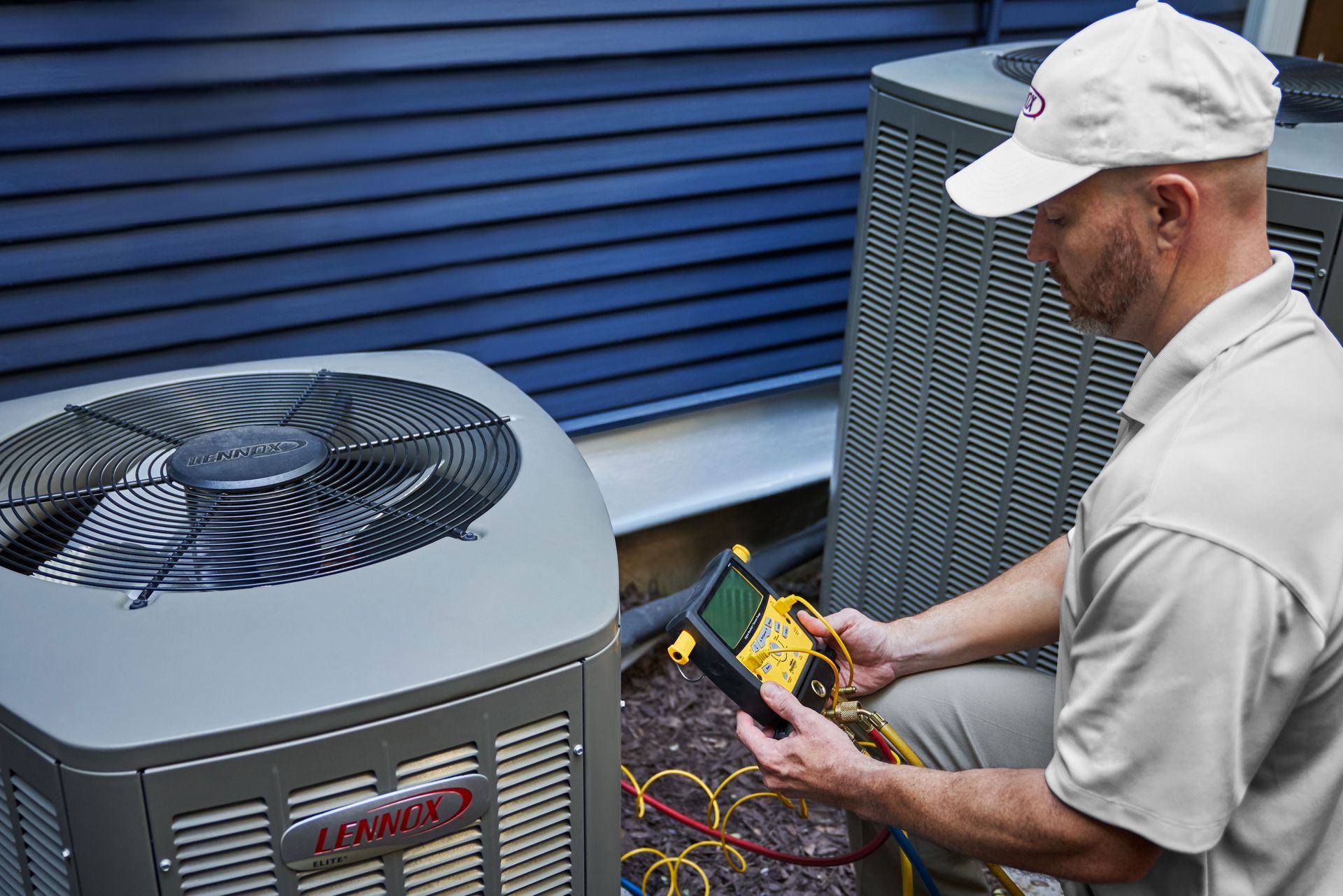 Service Technician running diagnostics on an air conditioner.