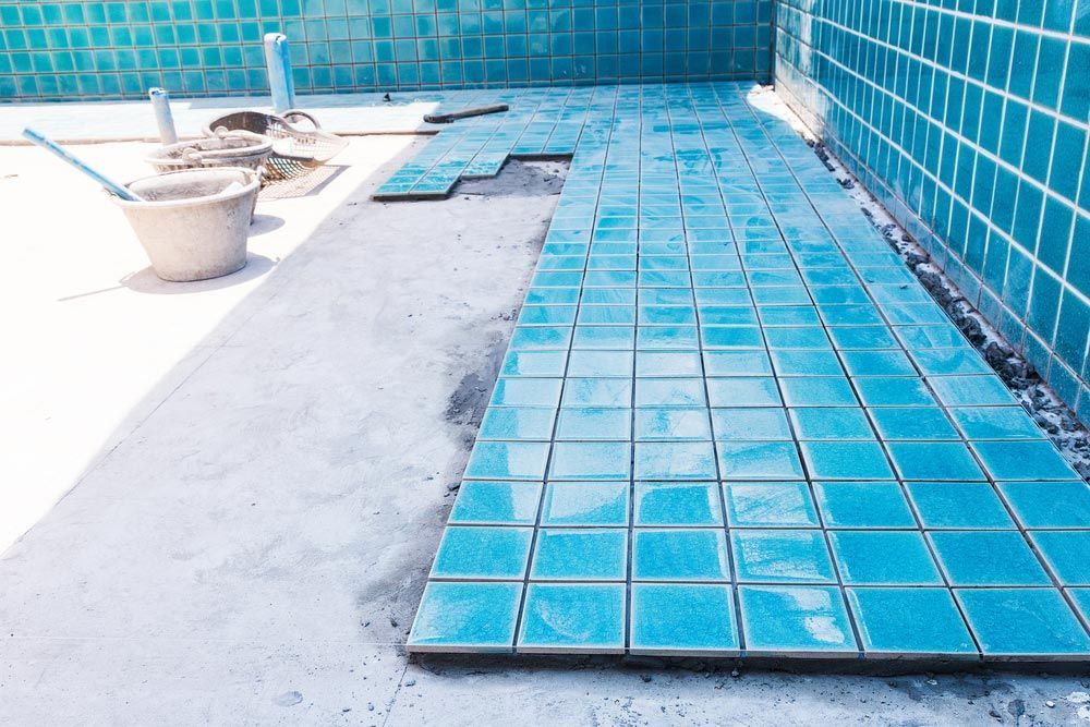 Industry Building Construction Architecture Worker Professional Man Builder Are Installation Blue Swimming Pool Ceramic Tiles On Cement Concrete Floors And Wall — Professional Pool Builder in Tumut, NSW