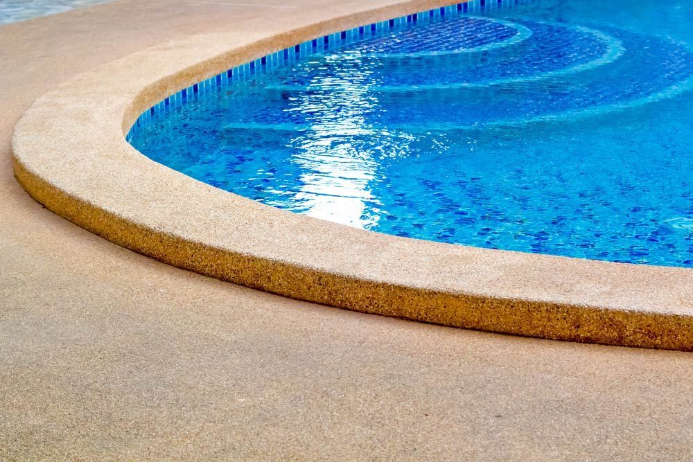 Clear Blue Water And Stone Edge Pool — Professional Pool Builder in Cootamundra, NSW