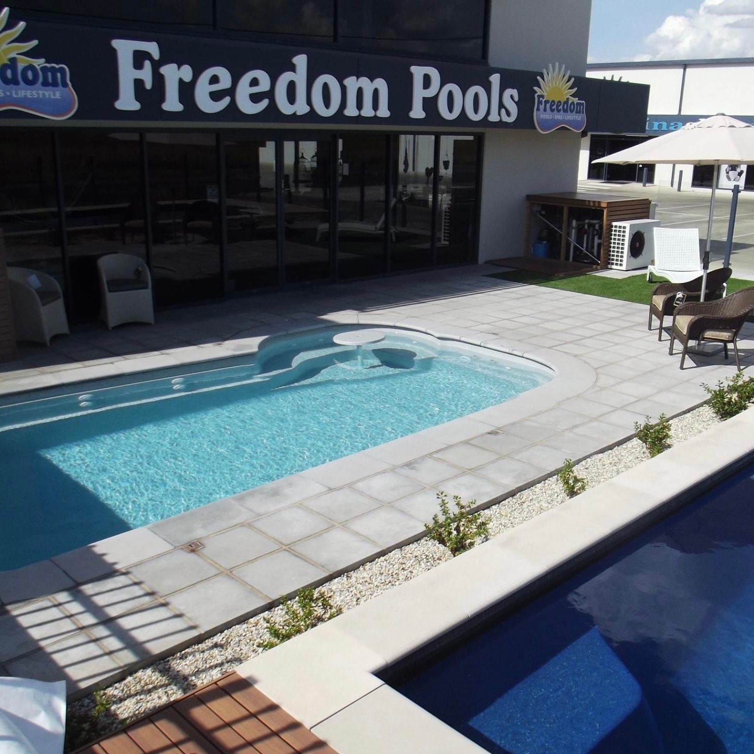 Family Jumping Into Swimming Pool — Professional Pool Builder in Wagga Wagga, NSW