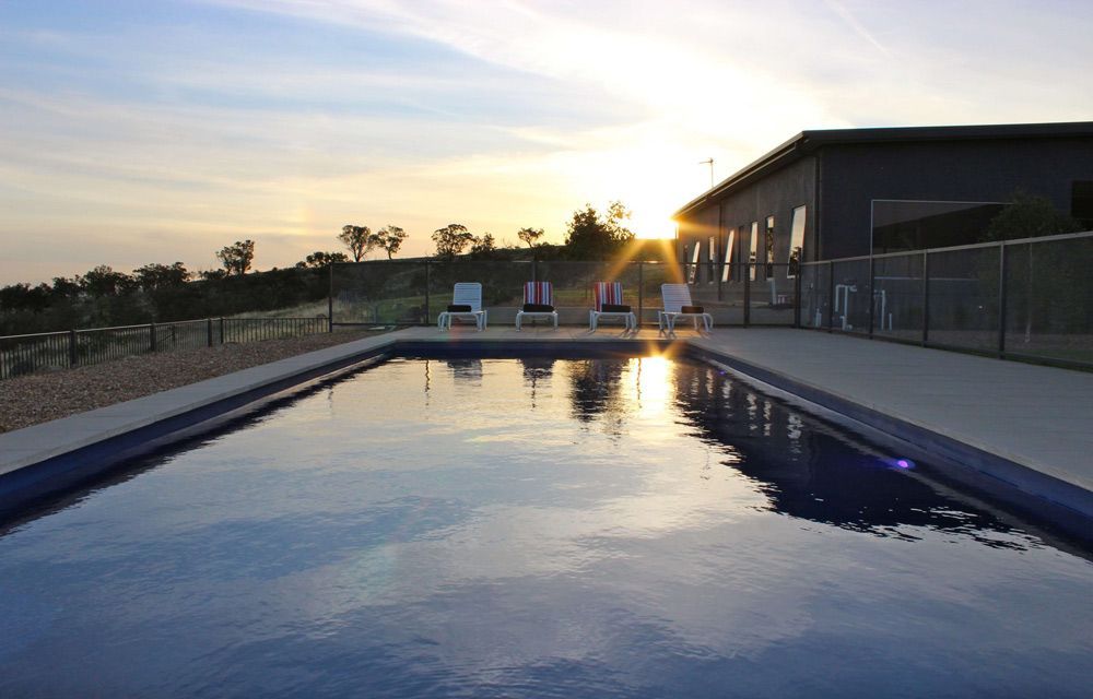 View Sunset And Swimming Pool — Professional Pool Builder in Wagga Wagga, NSW
