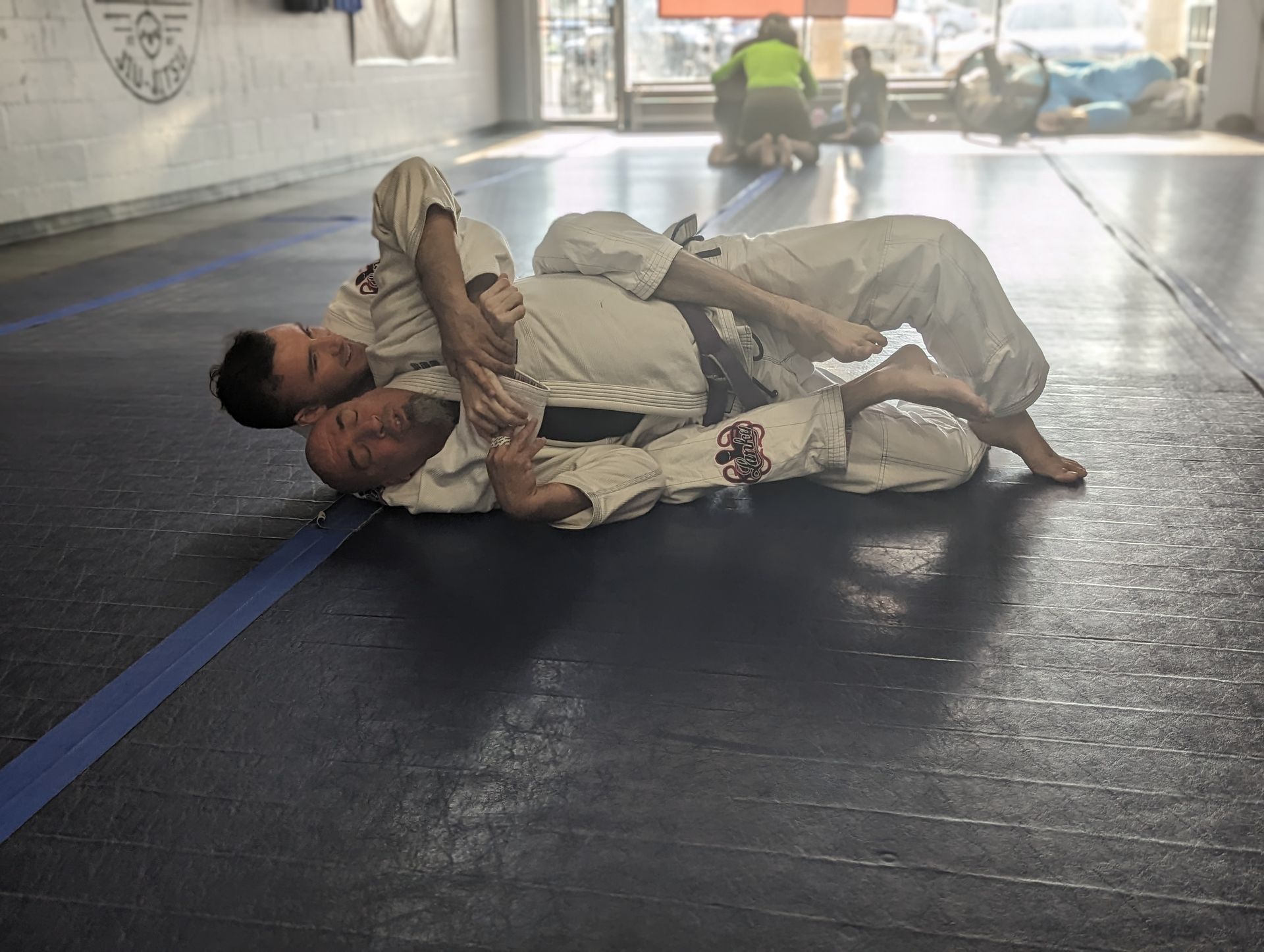 a man and a woman are practicing martial arts on a mat