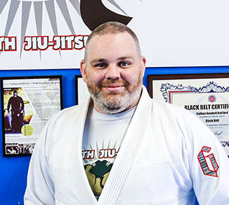 Carlos Machado wearing a white brazilian jiu jitsu uniform with the word machado on it