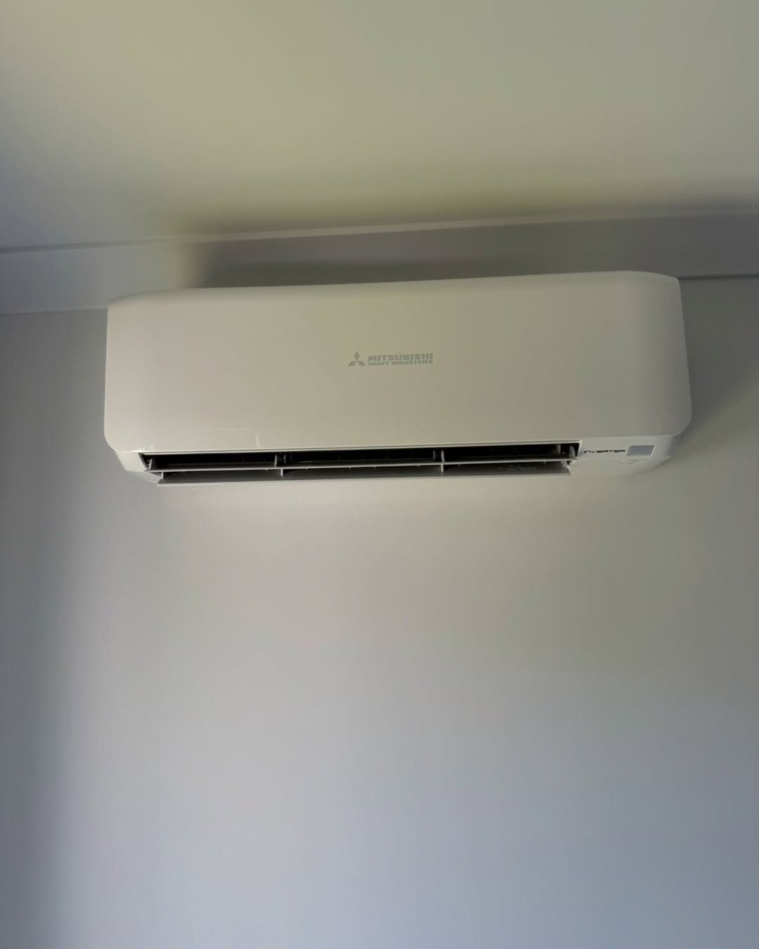 Mitsubishi wall-mounted split air conditioner installed indoors.