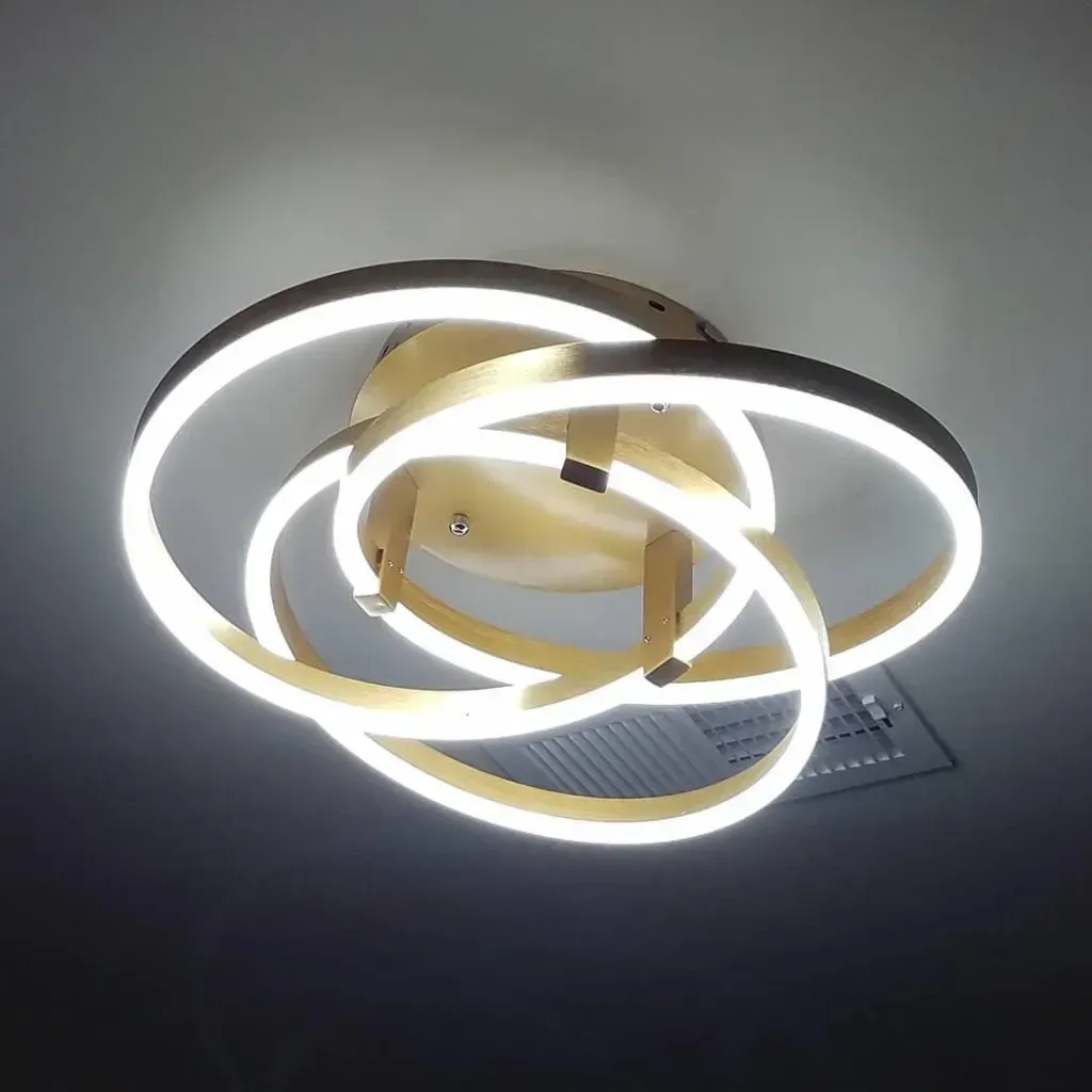 Modern spiral LED ceiling light fixture glowing in warm white.