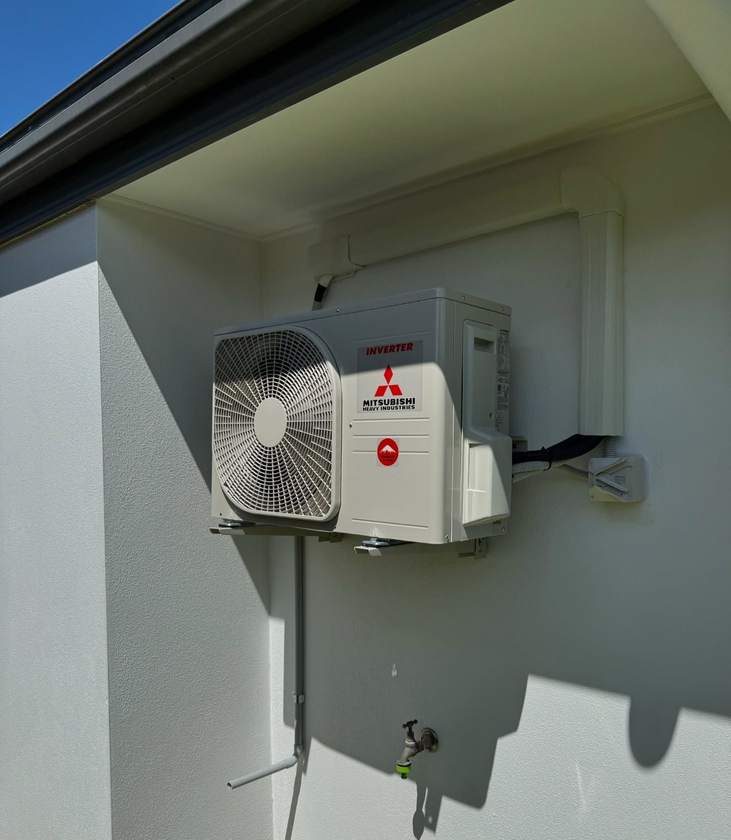 Wall-mounted Mitsubishi inverter air conditioning unit installed for energy efficiency