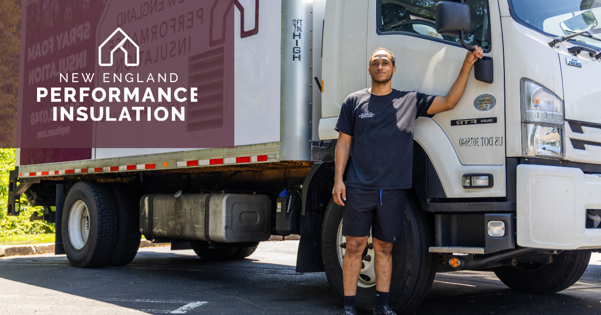 A person stands beside a commercial truck branded with 