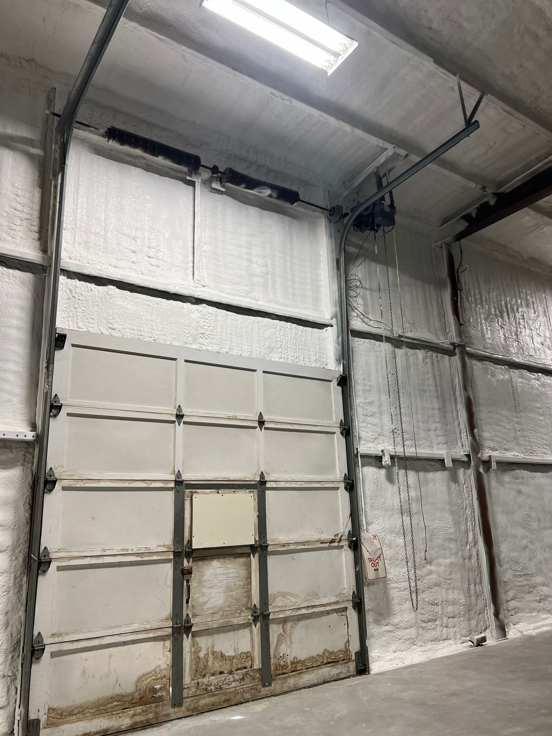 A garage door with a lot of insulation on it.