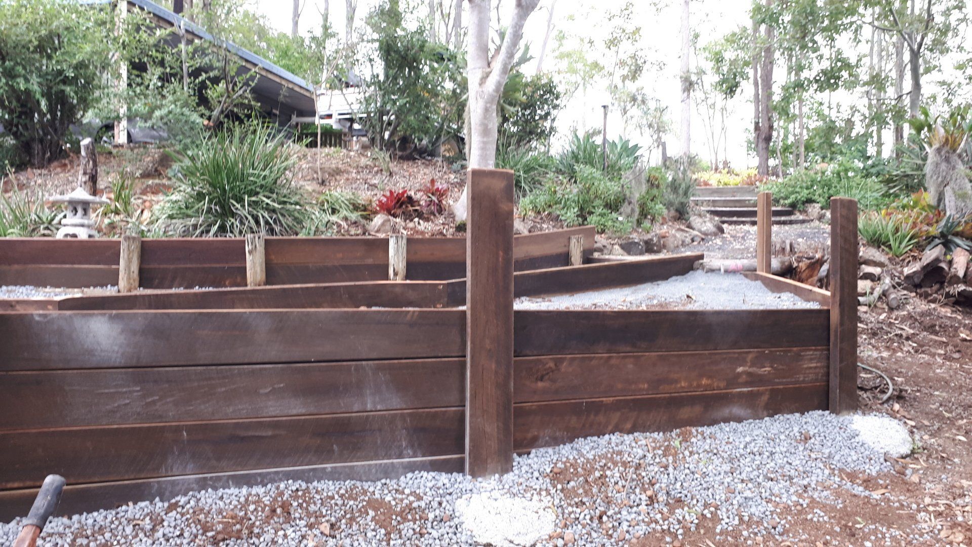 Timber retaining wall for walkway